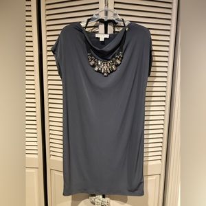 Michael Kors dark gray dress with detailed necklace.
